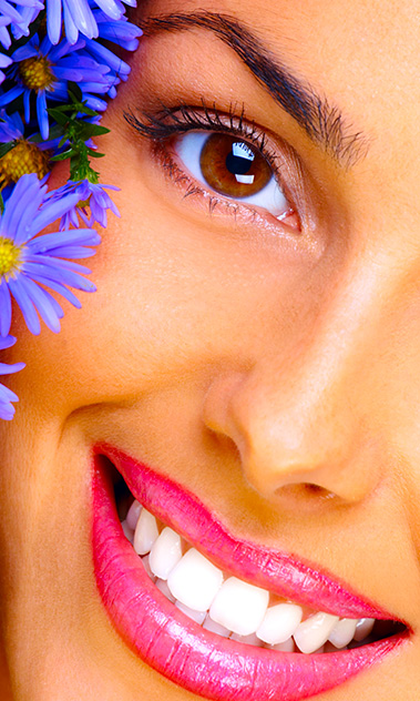 Woman Smiling with some purple flowers